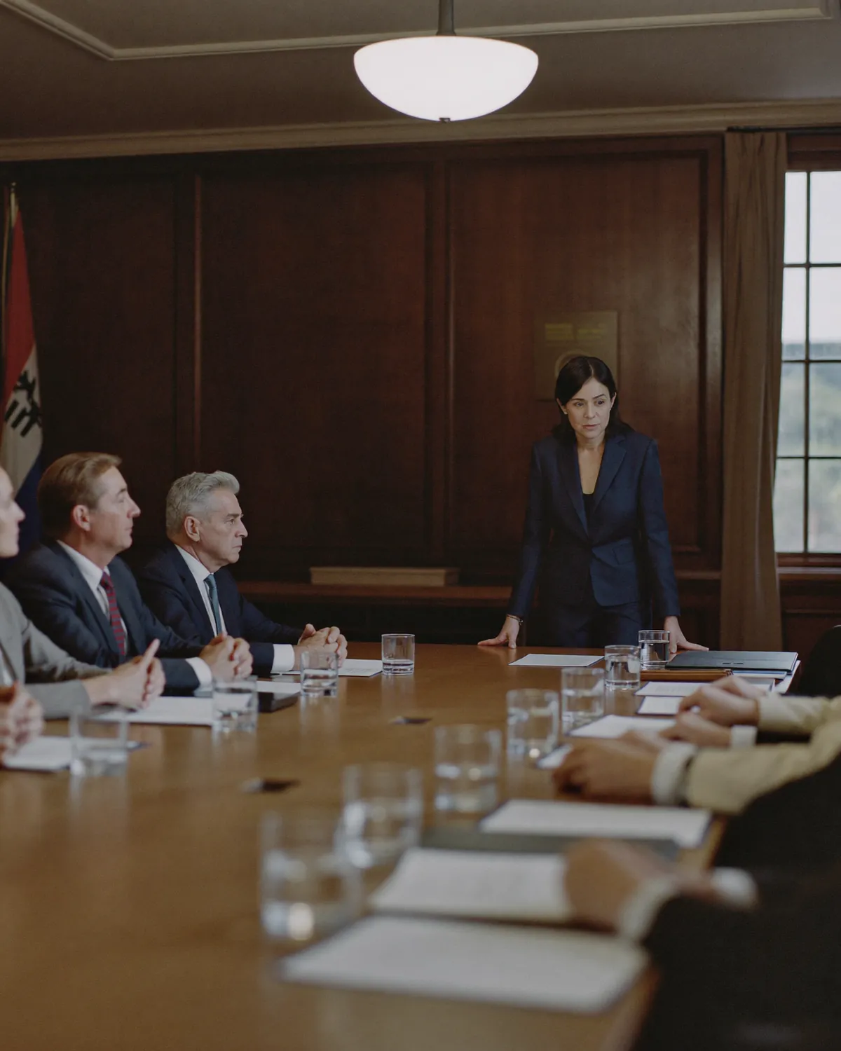 A formal briefing around a conference table in a government agency meeting room