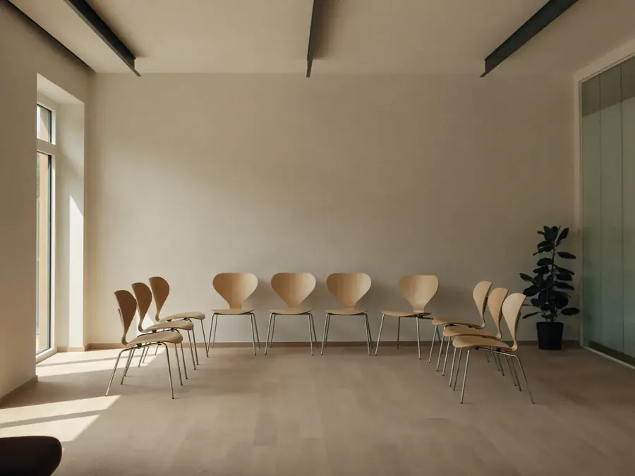 An empty training room set up before a session, morning light across the floor